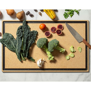 Chef Series Cutting Board in Natural paired with a Victorinox Swiss Modern Carving Knife expertly slicing up fruits and veggies